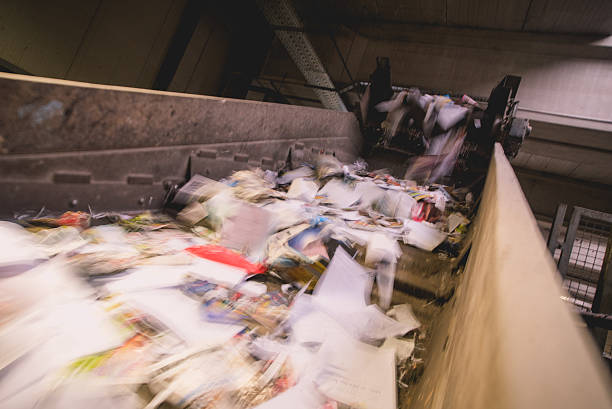 Trash moving on a conveyor belt, blurred motion.