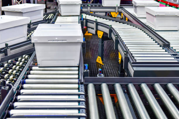 White plastic boxes on the roller conveyor. Modern warehouse equipment.