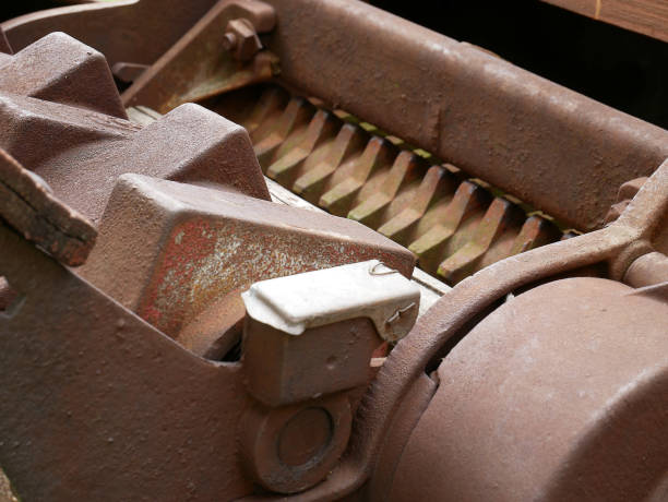 Old garden or agricultural shredder. Old machinery details closeup. Rusty gear wheels.