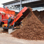 industrial wood shredder producing wood chips from bark